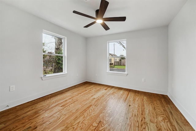 empty room with ceiling fan and light wood-type flooring