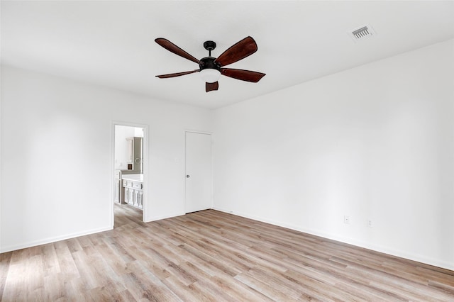 spare room with ceiling fan and light hardwood / wood-style flooring