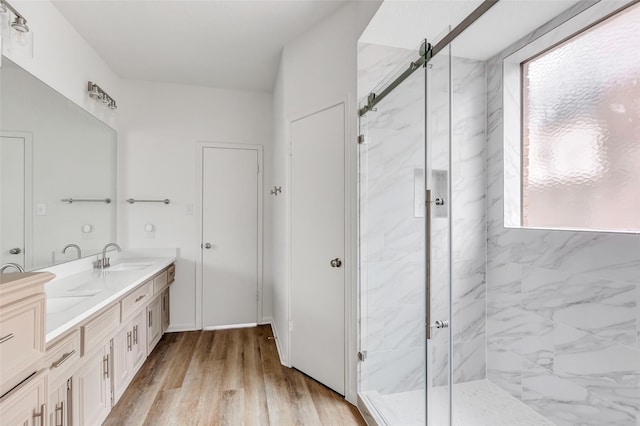 bathroom featuring vanity, hardwood / wood-style flooring, and a shower with door