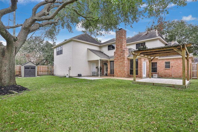 rear view of house featuring a storage shed, a pergola, a lawn, and a patio