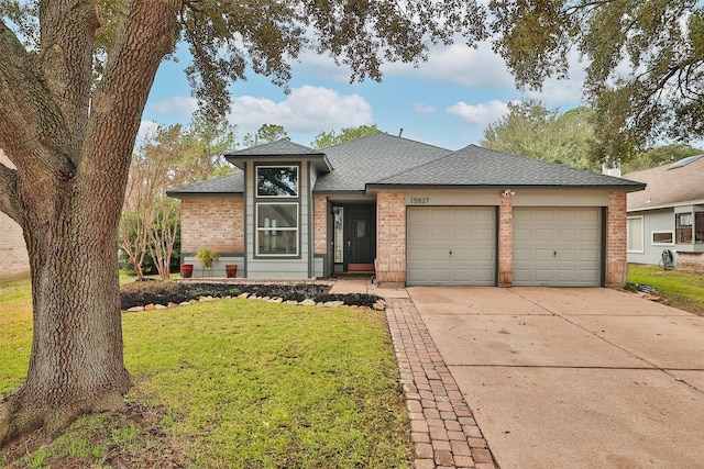 view of front of property featuring a garage and a front yard