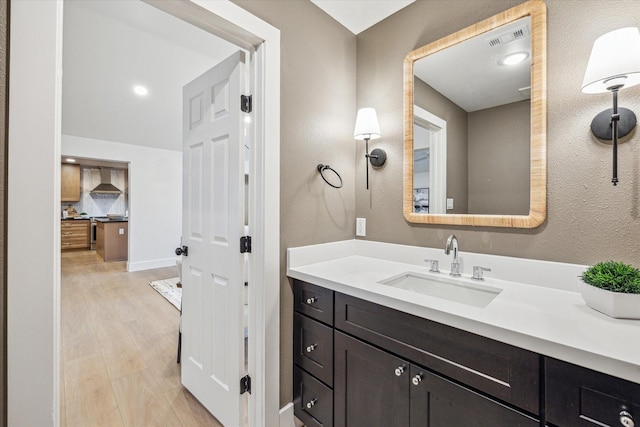 bathroom with vanity and hardwood / wood-style floors