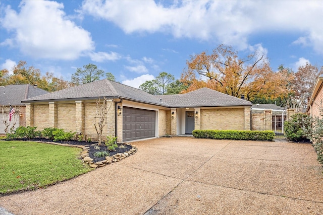 ranch-style home with a garage and a front yard