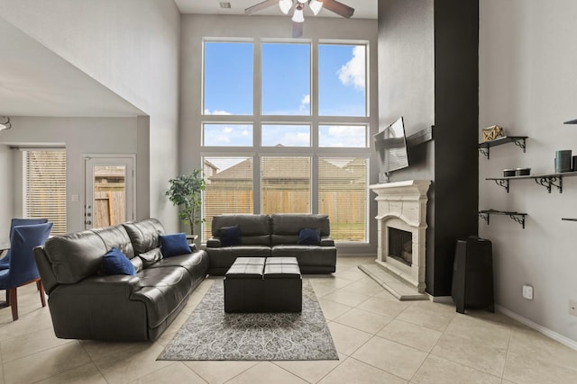 tiled living room featuring ceiling fan