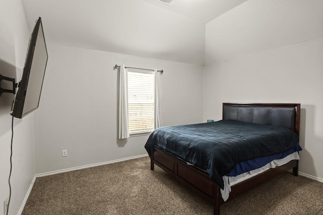 bedroom featuring vaulted ceiling and carpet