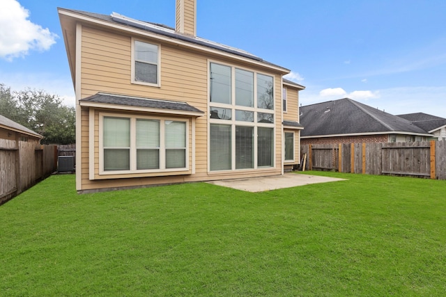 rear view of house featuring a yard, a patio area, and central air condition unit