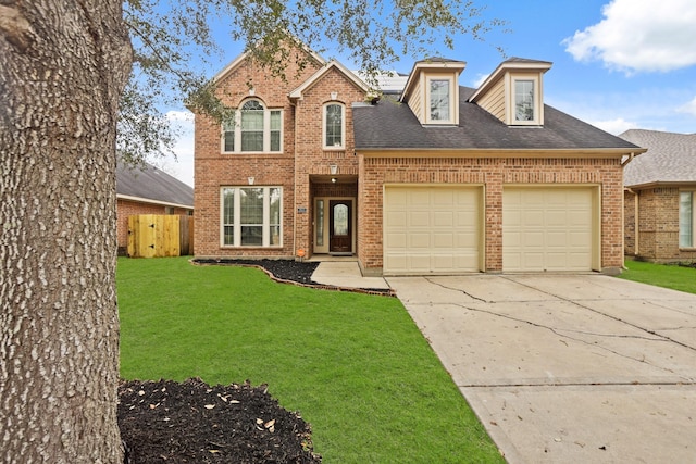 view of front of property featuring a garage and a front lawn