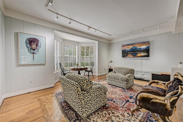 living room featuring crown molding and light wood-type flooring