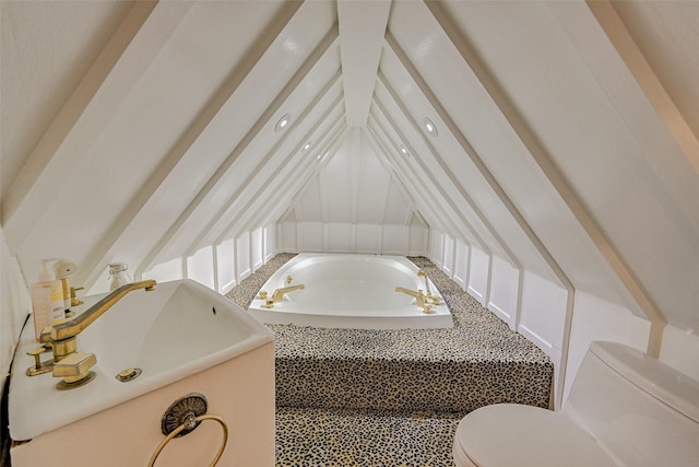 bathroom featuring vaulted ceiling, sink, tiled bath, and toilet