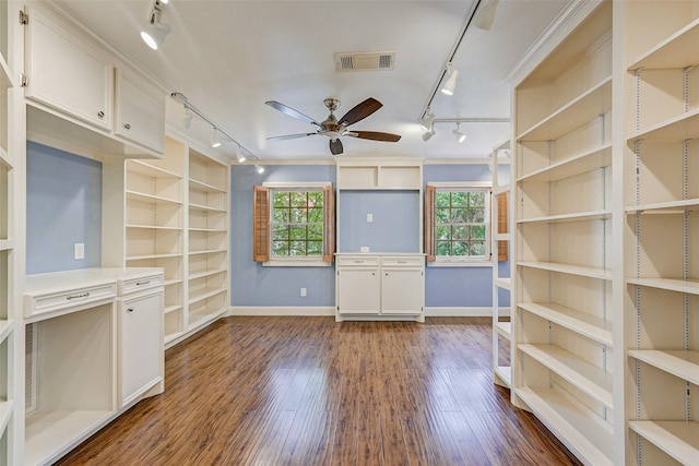 unfurnished living room featuring dark hardwood / wood-style flooring, built in features, and ceiling fan