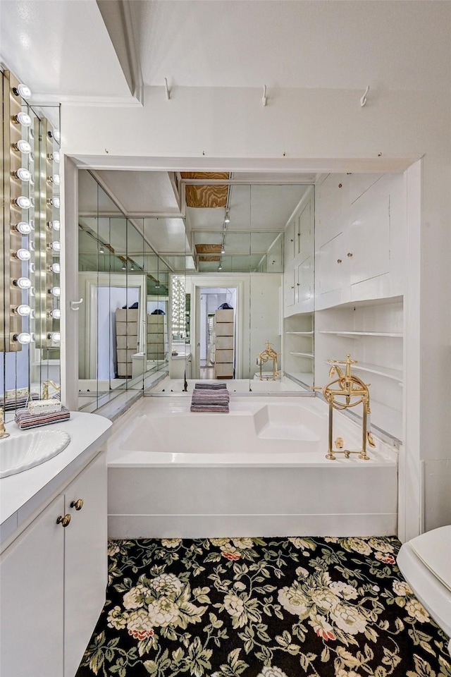 bathroom with vanity and a washtub