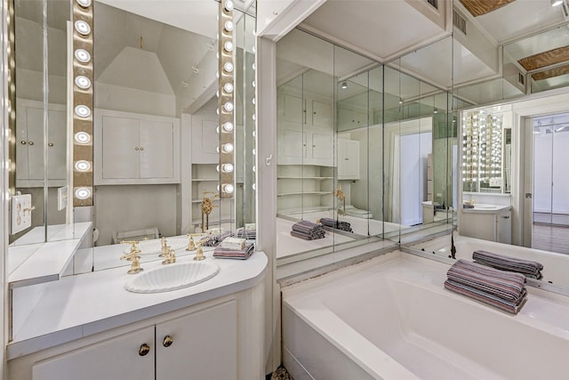 bathroom featuring vanity and a bath