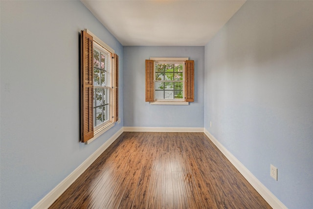 unfurnished room featuring dark hardwood / wood-style flooring