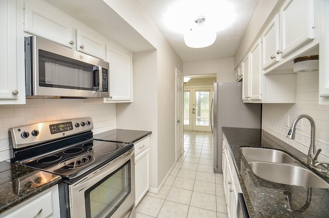 kitchen with stainless steel appliances and white cabinetry