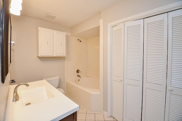 full bathroom featuring tile patterned floors, toilet, tub / shower combination, a textured ceiling, and vanity