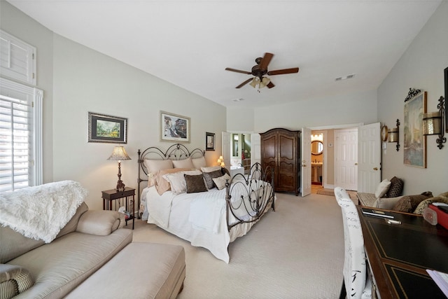 carpeted bedroom featuring connected bathroom and ceiling fan