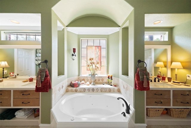 bathroom with crown molding, vanity, and a bathing tub