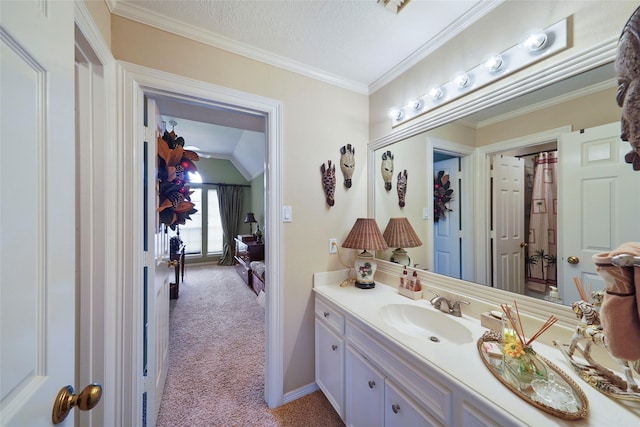 bathroom featuring vanity, vaulted ceiling, a textured ceiling, and crown molding