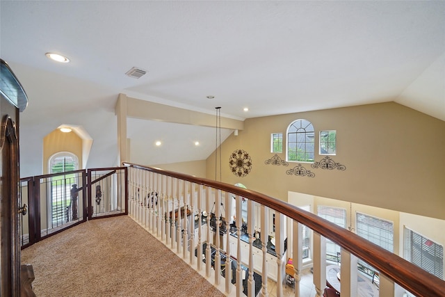 hallway featuring carpet floors and vaulted ceiling