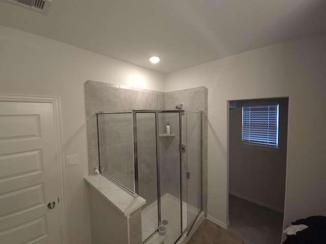 bathroom with tile patterned floors and a shower with shower door