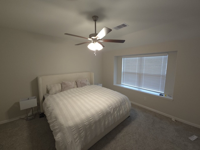 bedroom featuring ceiling fan and dark carpet