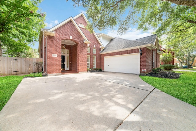 view of front property featuring a garage and a front lawn