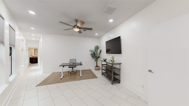 tiled office space featuring ceiling fan