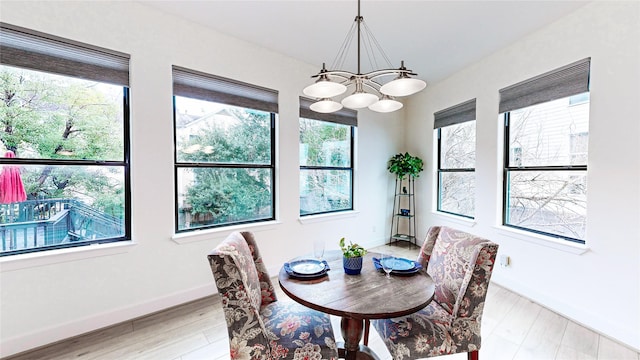 dining room featuring an inviting chandelier and light hardwood / wood-style flooring