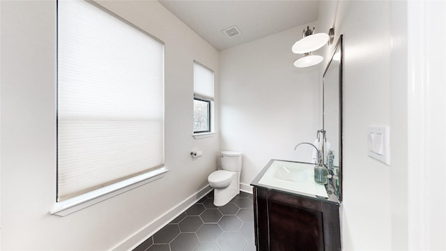 bathroom with vanity, tile patterned floors, and toilet