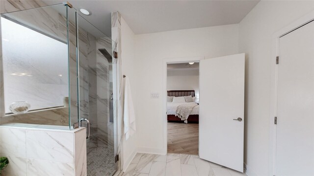 bathroom with a shower with door