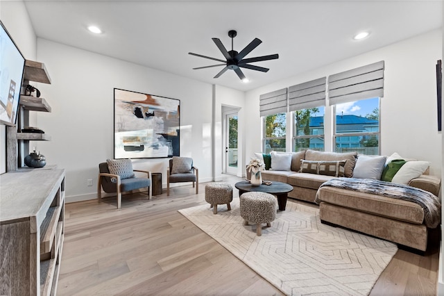 living room featuring ceiling fan and light hardwood / wood-style flooring