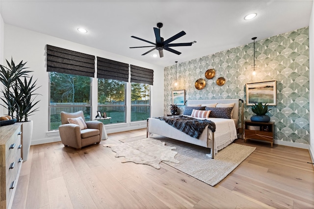 bedroom with ceiling fan and light hardwood / wood-style flooring