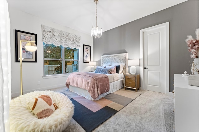 carpeted bedroom with a chandelier