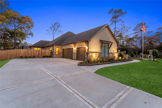 view of front facade with a garage and a yard