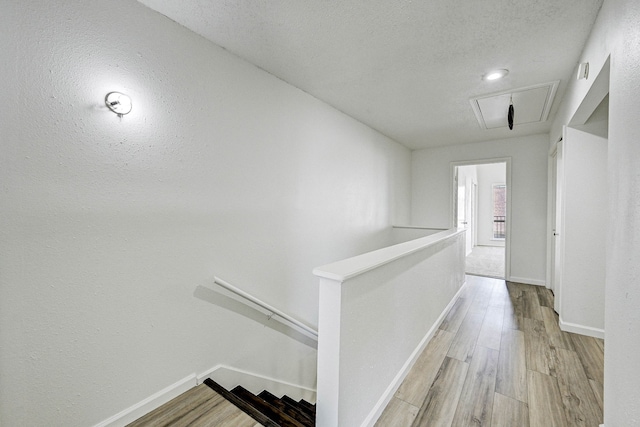 2022 Lakewood Ct, Willis, TX 77318 - corridor featuring wood finished floors, an upstairs landing, and baseboards