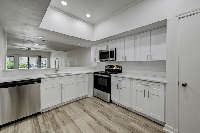 kitchen with white cabinetry, appliances with stainless steel finishes, and sink