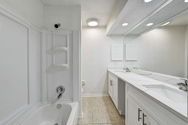 2022 Lakewood Ct, Willis, TX 77318 - bathroom featuring a textured wall, double vanity, a sink, and  shower combination