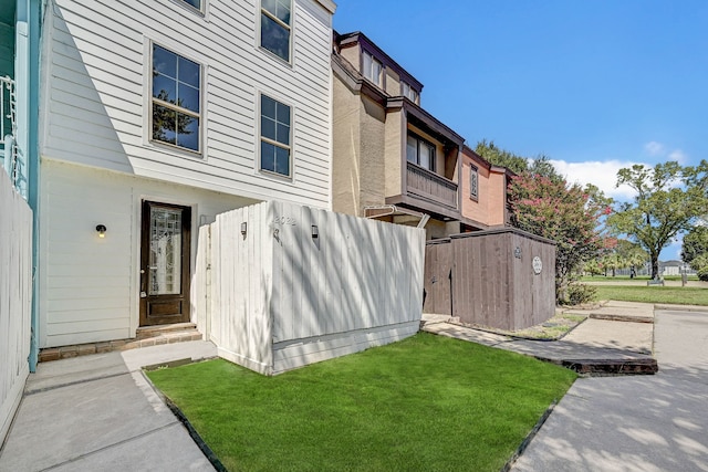 exterior space with a shed, fence, and an outdoor structure