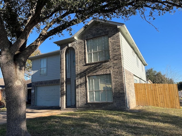 front of property featuring a garage and a front yard