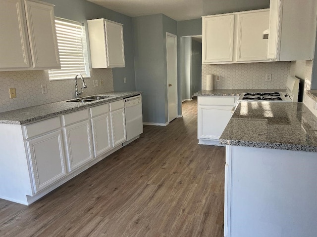 kitchen with range, dishwasher, sink, and white cabinets