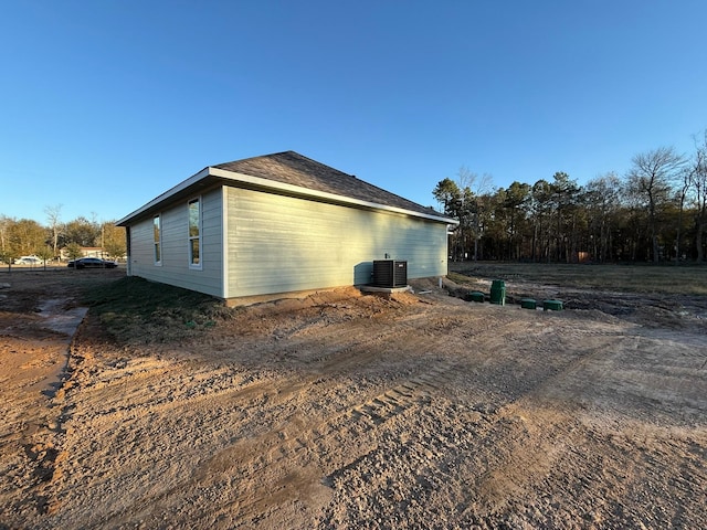 view of side of home featuring cooling unit