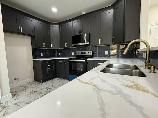 kitchen with tasteful backsplash, light stone countertops, sink, and electric range