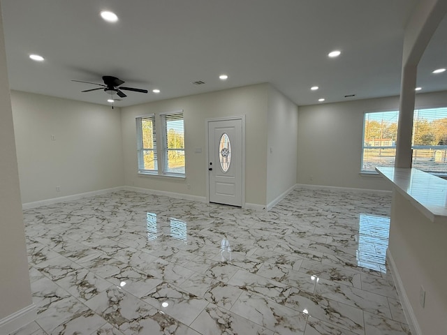 foyer with ceiling fan and plenty of natural light