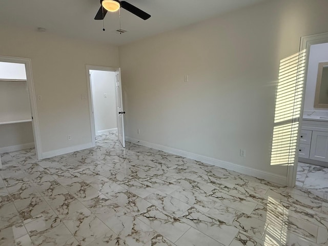 unfurnished bedroom featuring ceiling fan and ensuite bathroom