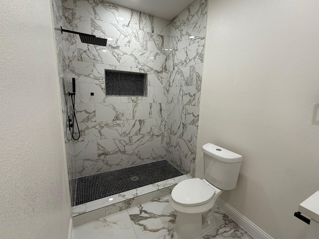 bathroom featuring toilet and tiled shower