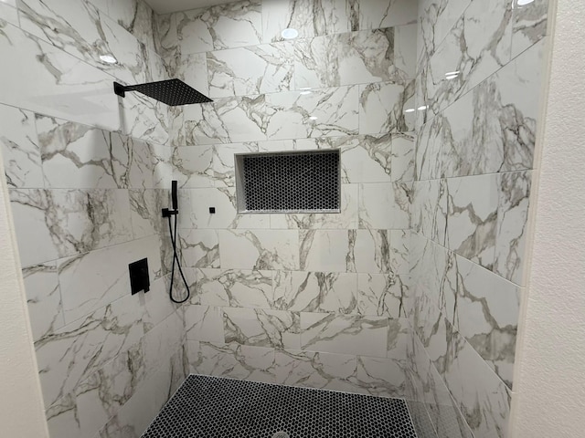 bathroom with tiled shower