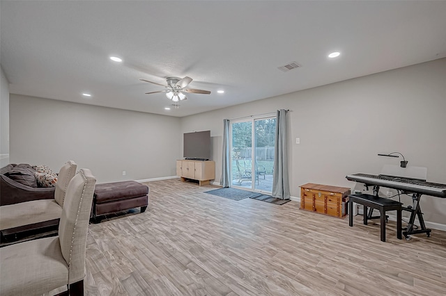 living room featuring ceiling fan and light wood-type flooring