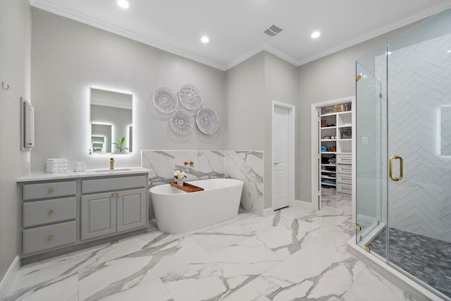 bathroom featuring ornamental molding, separate shower and tub, and vanity