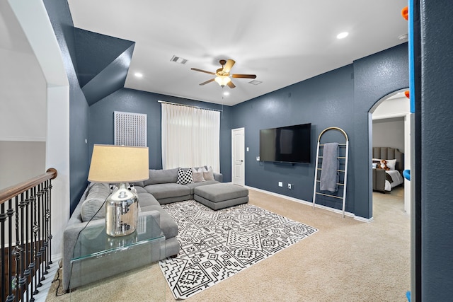 living room featuring lofted ceiling, light colored carpet, and ceiling fan