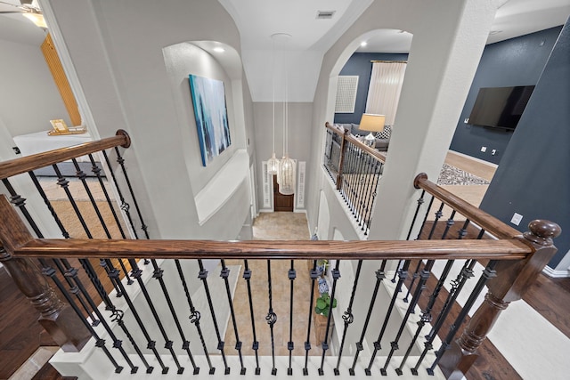 staircase with hardwood / wood-style flooring